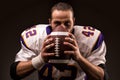 Portrait of american football player holding a ball and looking at camera Royalty Free Stock Photo