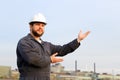 Portrait of american foreman with outstetched hands standing in construction site background. Royalty Free Stock Photo