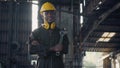 Engineer standing holding wrench tools and arms crossed at work in the industry Royalty Free Stock Photo