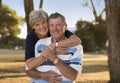 Portrait of American senior beautiful and happy mature couple around 70 years old showing love and affection smiling together in t