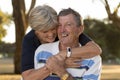 Portrait of American senior beautiful and happy mature couple around 70 years old showing love and affection smiling together in t