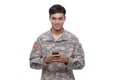 Portrait of an American soldier texting with a cell phone Royalty Free Stock Photo