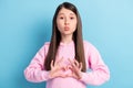 Portrait of amorous girl sending air kiss showing heart shape isolated over bright blue color background