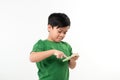 Portrait of an amused cute little kid playing games on smartphone isolated over white background