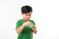 Portrait of an amused cute little kid playing games on smartphone isolated over white background