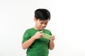 Portrait of an amused cute little kid playing games on smartphone isolated over white background