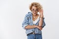 Really. Portrait of amused and entertained questioned attractive young 20s woman in glasses and denim looking from under
