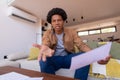 Portrait of angry african american young businessman gesturing over video while working at home Royalty Free Stock Photo