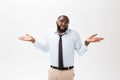 Portrait of angry or annoyed young African American man in white polo shirt looking at the camera with displeased