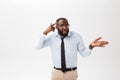 Portrait of angry or annoyed young African American man in white polo shirt looking at the camera with displeased