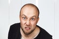 Portrait of angry bald man aggressive thug threatens. Concept portrait of a dangerous criminal