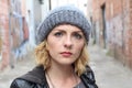 Portrait angry blonde woman on urban cool background