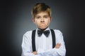 Portrait of angry boy on gray background. Negative human emotion, facial expression. Closeup Royalty Free Stock Photo