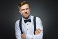 Portrait of angry boy isolated on gray background. Negative human emotion, facial expression. Closeup Royalty Free Stock Photo