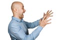 Portrait angry dangerous bald man trying to watch and scare on white isolated background