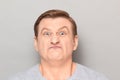 Portrait of angry disgruntled mature man making crazy face Royalty Free Stock Photo