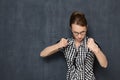 Portrait of angry dissatisfied girl holding fists in front of her