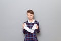 Portrait of angry furious young blond woman tearing paper sheet