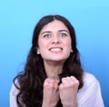 Portrait of angry girl against blue background