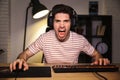 Portrait of angry irritated gamer guy screaming while playing vi