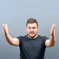 Portrait of a angry man screaming against gray background Royalty Free Stock Photo