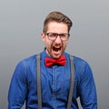 Portrait of a angry man screaming against gray background Royalty Free Stock Photo