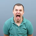 Portrait of a angry man screaming against gray background Royalty Free Stock Photo