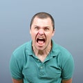 Portrait of a angry man screaming against gray background Royalty Free Stock Photo