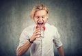 Portrait of an angry man screaming into empty glass jar Royalty Free Stock Photo