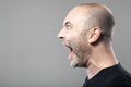 Portrait of angry man screaming isolated on gray background