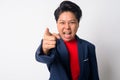 Portrait of angry mature Asian businesswoman shouting and pointing at camera