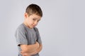 Portrait of angry and sad little boy on white background