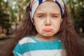 Portrait of angry and sad little girl. Children`s emotions