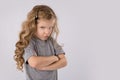 Portrait of angry and sad little girl isolated on white background