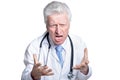 Portrait of angry senior male doctor posing against white background