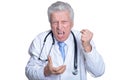 Portrait of angry senior male doctor with stethoscope isolated Royalty Free Stock Photo