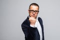 Portrait of an angry senior man shaking his fist looking to the camera aggressively isolated on white. Royalty Free Stock Photo