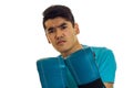 Portrait of angry sportsman with dark hair practicing boxing in blue gloves and uniform isolated on white background Royalty Free Stock Photo