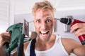 Technician Holding Electric Drill And Screwdriver On His Head