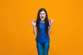 Portrait of angry teen girl on a orange studio background Royalty Free Stock Photo