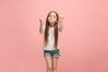 Portrait of angry teen girl on a pink studio background Royalty Free Stock Photo