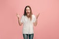 Portrait of angry teen girl on a pink studio background Royalty Free Stock Photo