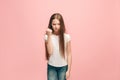 Portrait of angry teen girl on a pink studio background Royalty Free Stock Photo