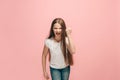 Portrait of angry teen girl on a pink studio background Royalty Free Stock Photo