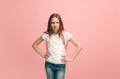 Portrait of angry teen girl on a pink studio background Royalty Free Stock Photo