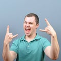 Portrait of a angry threatening man screaming against gray background Royalty Free Stock Photo