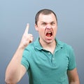 Portrait of a angry threatening man screaming against gray background Royalty Free Stock Photo