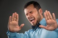 Portrait angry upset young man in blue shirt, butterfly tie Royalty Free Stock Photo