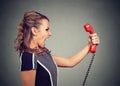 Portrait of an angry woman yelling at the phone Royalty Free Stock Photo