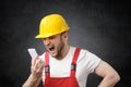 Construction worker shouting on the phone Royalty Free Stock Photo